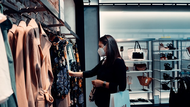 Image of woman shopping with a face mask.
