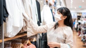 Image of Asian woman wearing face mask while shopping.