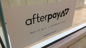 Afterpay App sticker placed on a shopfront window at the Sunshine Plaza Mall.