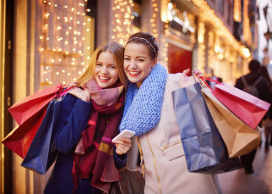 two-girls-shopping-bags-390x279