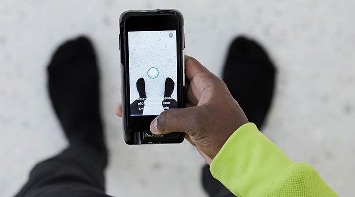 A customer holding a mobile phone with the Nike app open.