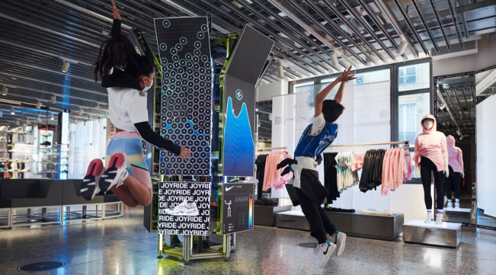 Kids jumping in the air during an interactivity experience at the Nike House of Innovation.