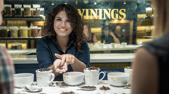 A friendly teacher holds tea in her hand during a blending masterclass at the Twinings store.