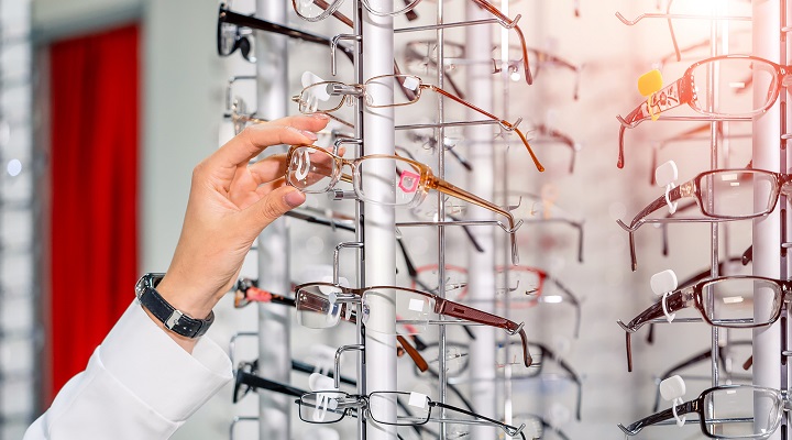Image of a person picking up a pair of glasses