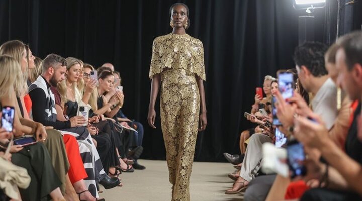 a model wearing gold attire gracing the australian fashion week