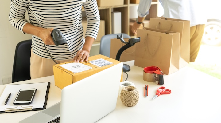 ecommerce concept, in office or home working prepare product in the box for send to customer who order by online. box for logistic with barcode scanner