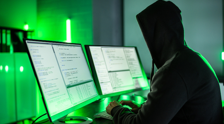 Image of hacker using computers.