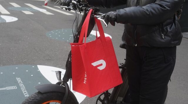 A DoorDash delivery person is pictured on the day they hold their IPO in the Manhattan borough of New York City